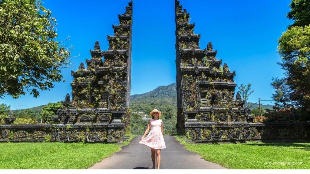 “Tourist posing at Handara Gate with mountain backdrop.jpg