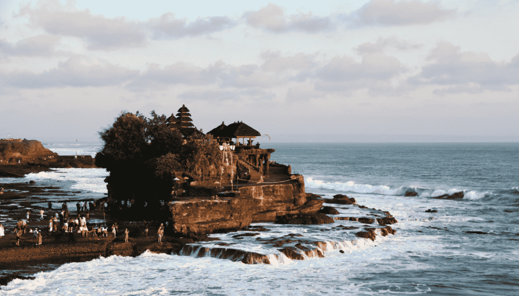 Tanah Lot Temple Bali at sunset with ocean view.png