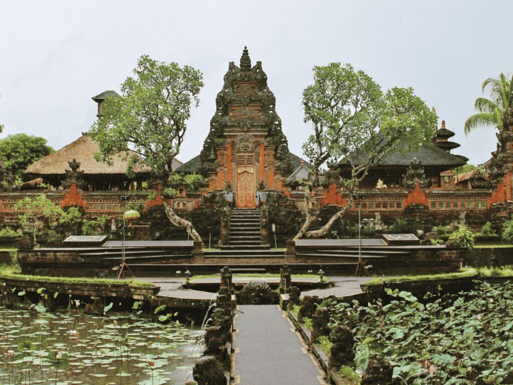 Tourists exploring Saraswati Temple Ubud with blooming lotus flowers