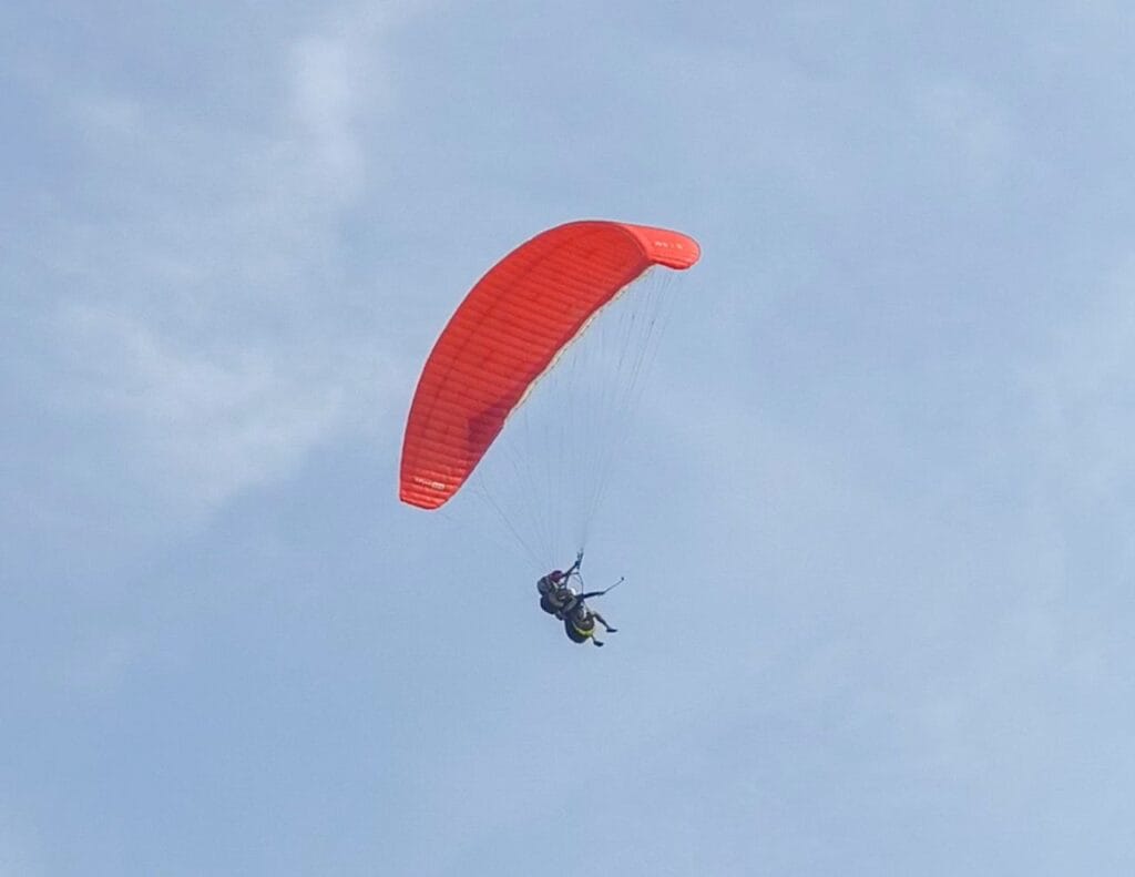 Paragliding Bali Uluwatu sunset flight over ocean cliffs