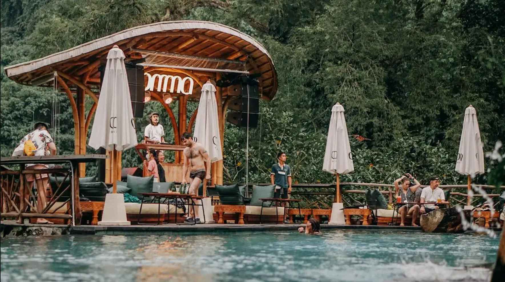 Relaxing tropical atmosphere at Omma Waterfall Bali with infinity pool and waterfall scenery