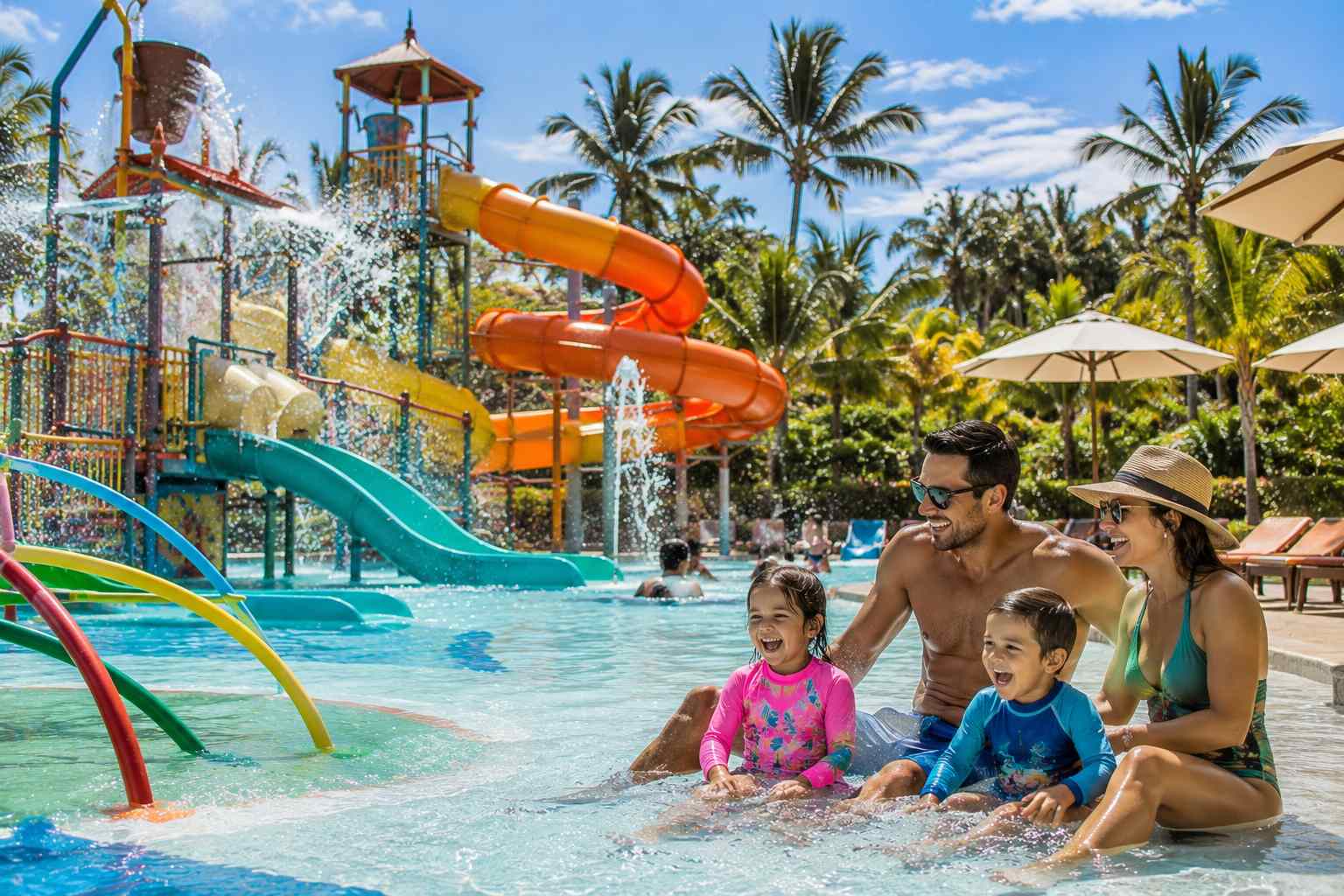 Tourists enjoying a tropical family experience at the best waterparks in Bali