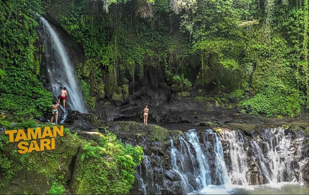 Taman Sari Waterfall Bali surrounded by lush tropical greenery