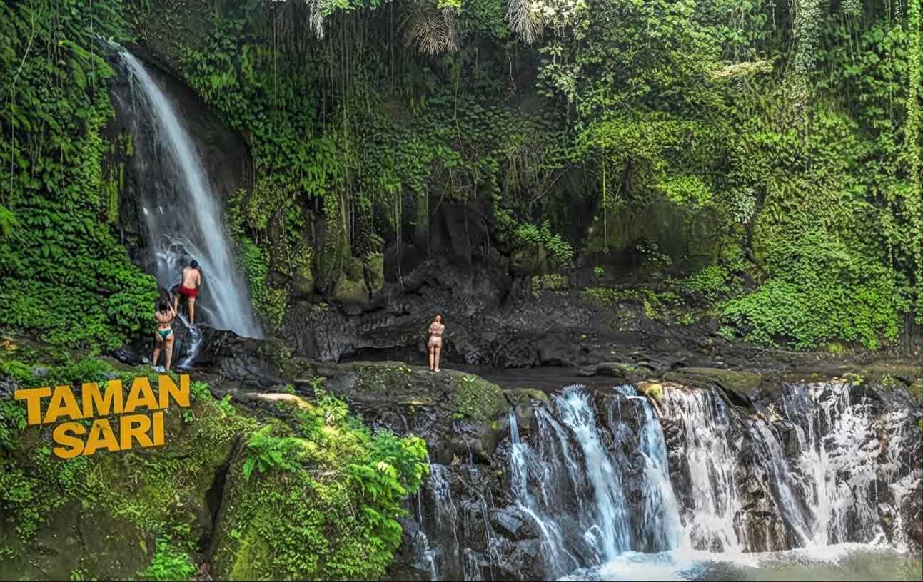 Taman Sari Waterfall Bali surrounded by lush tropical greenery